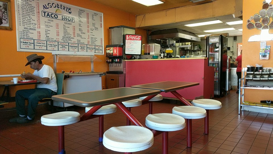 Taco restaurant with a humble counter and dining area.