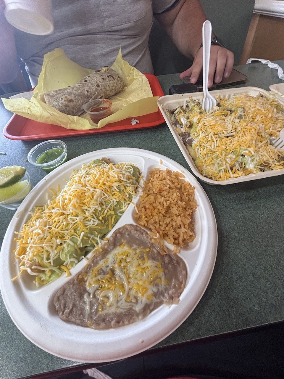 Menu board with tacos, burritos, and breakfast options.