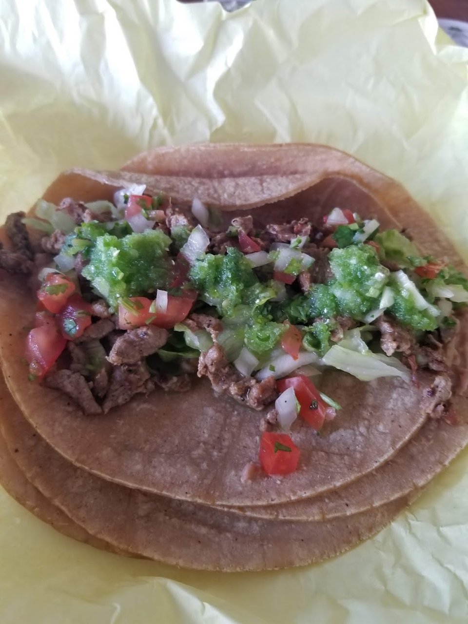 Menu board with tacos, burritos, and breakfast options.